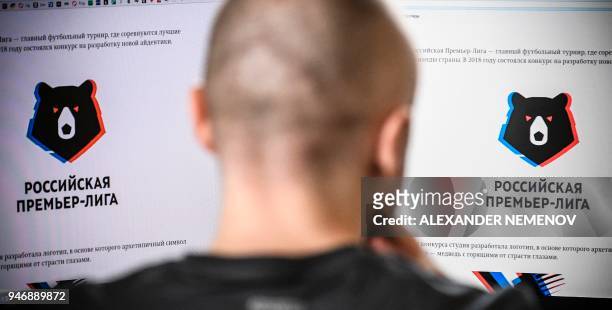 Man looks at computer screens showing the Russian Premier League's proposed logo in Moscow on April 16, 2018. The English Premier League is known to...