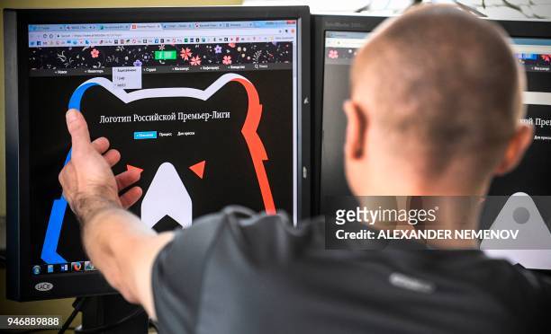 Man looks at a computer screen showing the Russian Premier League's proposed logo in Moscow on April 16, 2018. The English Premier League is known to...