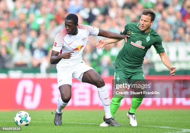 Philipp Bargfrede of Bremen is challenged by Ibrahima Konat of Leipzig during the Bundesliga match between SV Werder Bremen and RB Leipzig at...