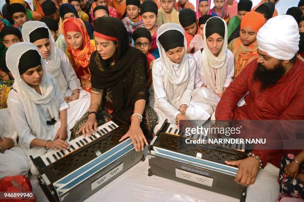 Religious Sikh preachers Anantvir Singh and Ravinder Kaur Tuli of the Canada based music academy 'Maadho Music' provide free training of 'Kirtan'...