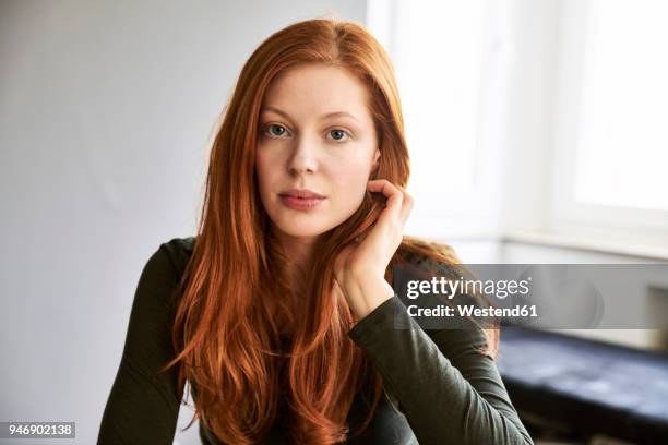 portrait of serious redheaded woman - 髪に手をやる　女性 ストックフォトと画像