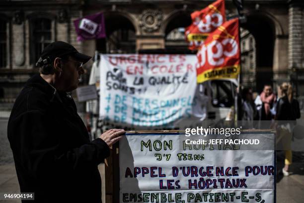 Employees of Lyon's hospitals emergency services demonstrate on April 16, 2018 in front the town hall in Lyon, central eastern France, to protest...