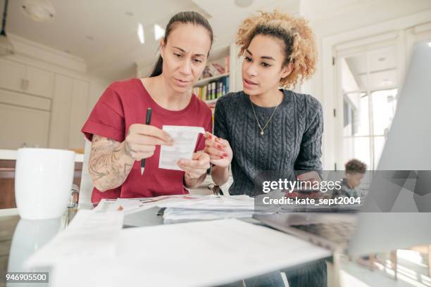 lgbtq couple doing business - couple counting money stock pictures, royalty-free photos & images