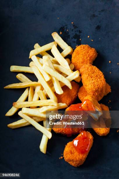 chicken nuggets with sweet chili sauce and french fries on dark ground - chili sauce stock pictures, royalty-free photos & images