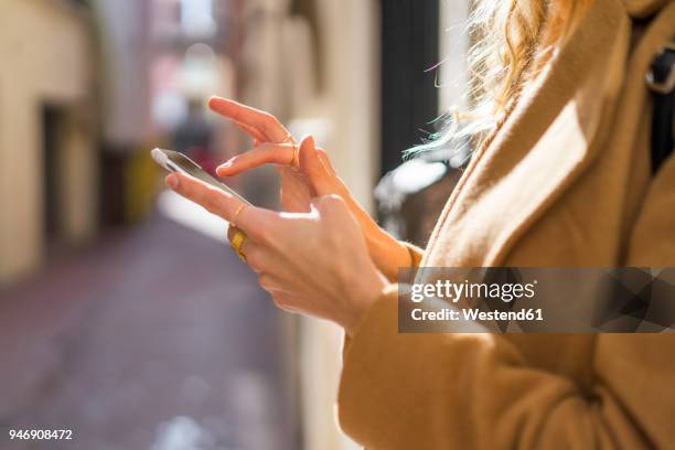 closee-up of young woman in a lane using cell phone - snapchat stock pictures, royalty-free photos & images