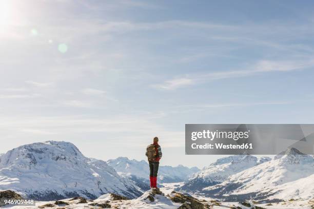 switzerland, engadin, hiker in mountainscape looking at view - man snow stock pictures, royalty-free photos & images