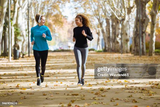 Two People Running Towards Each Other Photos and Premium High Res ...