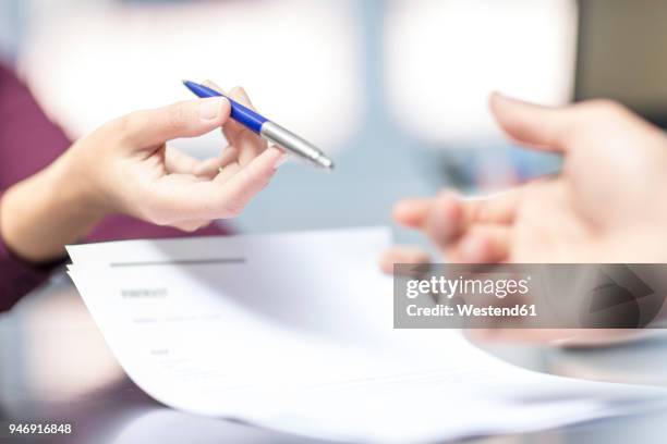 handing over of a pen over document - grant writer stock pictures, royalty-free photos & images