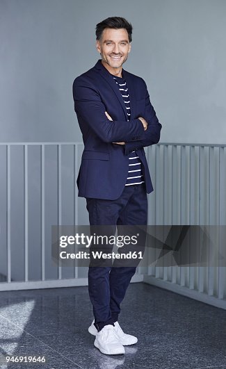Portrait of smiling businessman with stubble wearing blue suit Portrait of smiling businessman with stubble wearing blue suit