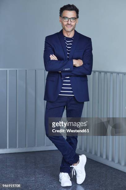 portrait of fashionable businessman with wearing blue suit and glasses - abbigliamento elegante foto e immagini stock