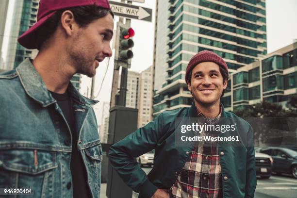 two young men in the city on the move - san francisco design center stock pictures, royalty-free photos & images