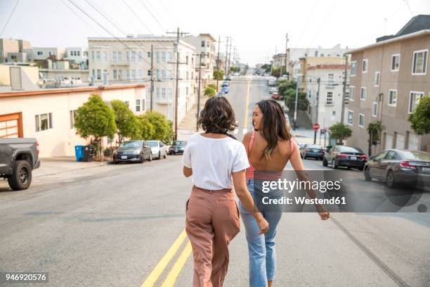 two young women walking down the street - san francisco street stockfoto's en -beelden