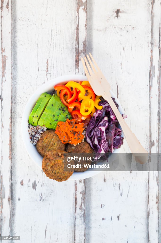 Quinoa-Buddha-Bowl with paprika, avocado, red cabbage, quinoa, quinoa patty, ajvar and black sesame