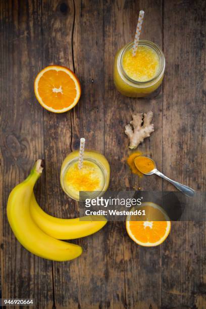 orange banana smoothie with ginger and curcuma - orange powder ストックフォトと画像