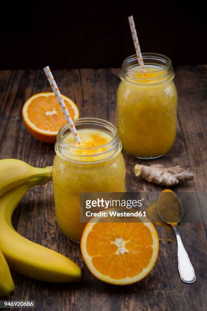 orange banana smoothie with ginger and curcuma - curcuma stock pictures, royalty-free photos & images
