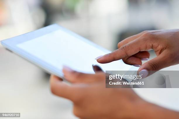 close-up of woman's hands using tablet outdoors - human body part stock pictures, royalty-free photos & images