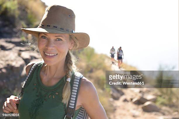portrait of smiling woman on a hiking trip - mature adult hiking stock pictures, royalty-free photos & images