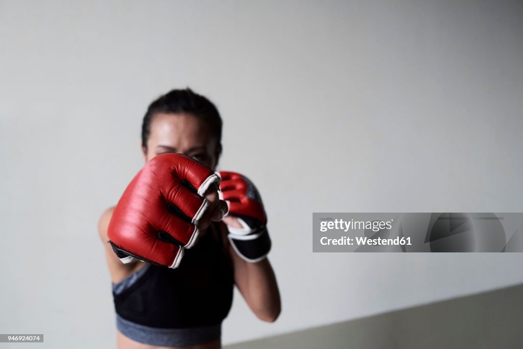 Boxing glove of a female boxer exercising