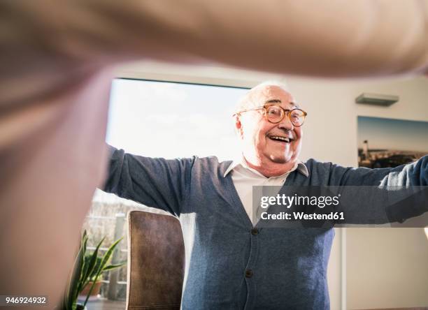 happy senior man with outstretched arms - old man laughing stock pictures, royalty-free photos & images