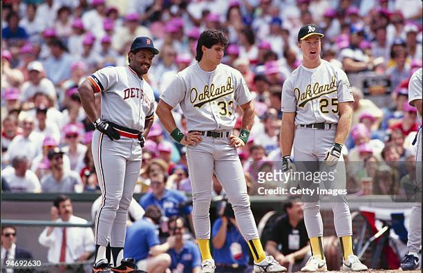 Cecil Fielder of the Detroit Tigers, Jose Canseco and Mark McGuire of the Oakland Athletics look on during batting practice prior to the1990 All-Star...
