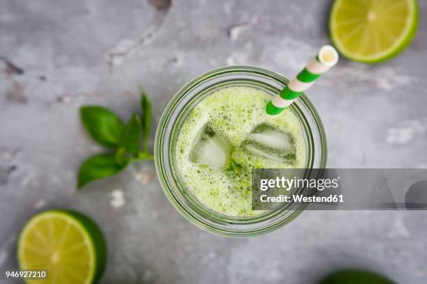 glass of organic lime lemonade with basil - lime juice stock pictures, royalty-free photos & images