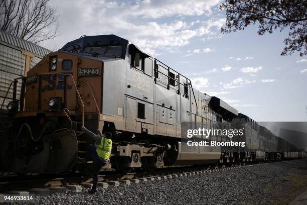Transportation Inc. Conductor climbs aboard a freight train in Bowling Green, Kentucky, U.S., on Friday, April 13, 2018. CSX Corp. Is scheduled to...