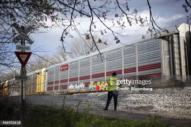 Transportation Inc. Conductor performs a visual inspection as an autorack train passes on a siding in Bowling Green, Kentucky, U.S., on Friday, April...