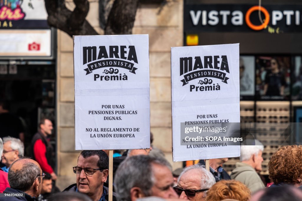 Two posters in defense of decent pensions are seen among the...