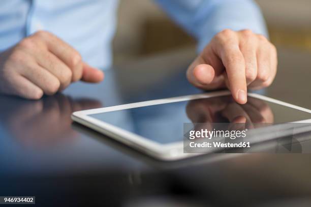 man using tablet in office, close-up - finger tablet stock-fotos und bilder