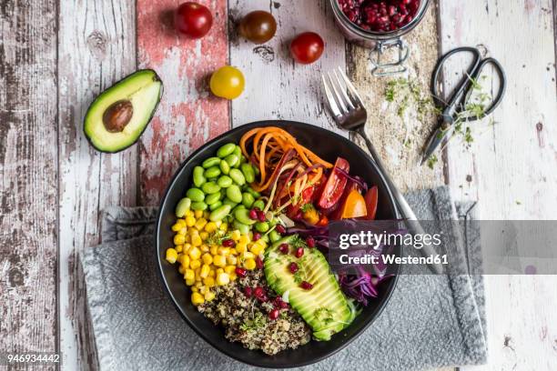 quinoa veggie bowl of avocado, edamame, tomatoes, corn, carrots, red cabbage and pomegranate seed - avocado salad stock pictures, royalty-free photos & images