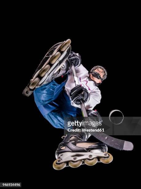 athlete playing roller hockey, view from below - ijshockeytenue stockfoto's en -beelden