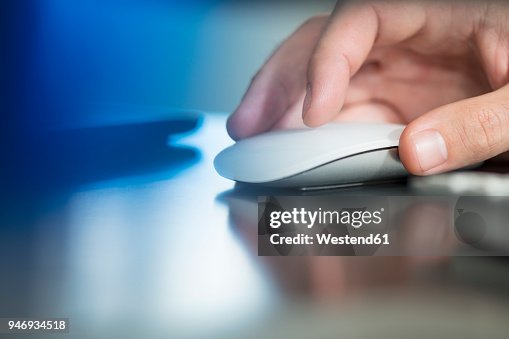 Man's hand using computer mouse Man's hand using computer mouse