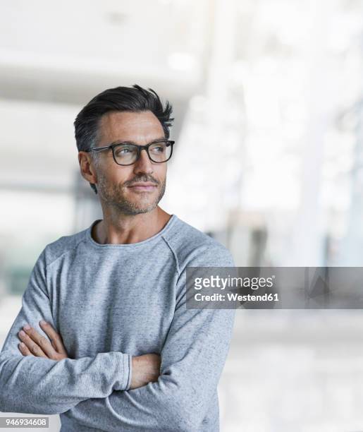 portrait of content mature man with stubble wearing glasses - looking away stock-fotos und bilder