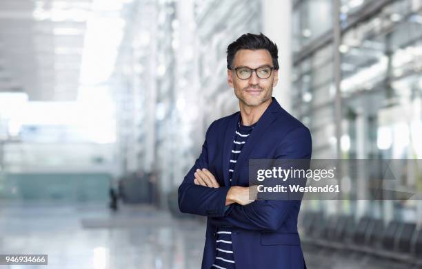 portrait of stylish businessman with stubble wearing blue suit and glasses - gestreept jak stockfoto's en -beelden