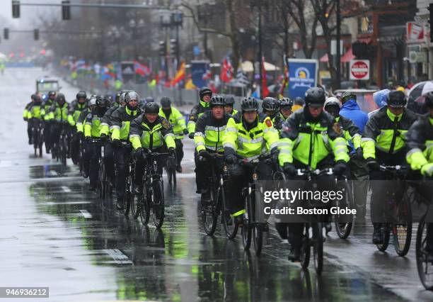 Police ride toward the Boston Marathon finish line on Boylston Street in Boston on April 16, 2018.