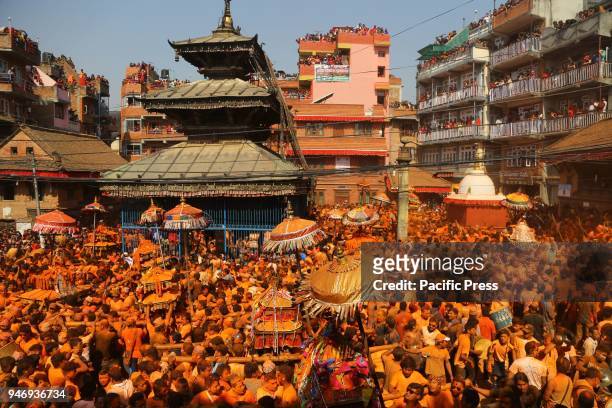 Devotees carry chariots of various deities during the celebration of traditional "Sindoor Jatra" Festival at Thimi in Bhaktapur. The festival is...