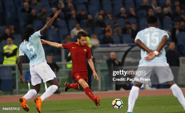 Roma's Alessandro Florenzi, center, is challenged by Lazio s Jordan Lukaku, left, and Bastos, during the Serie A soccer match between Lazio and Roma...