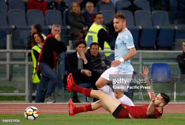 Lazio s Ciro Immobile, left, and Roma s Kostas Manolas fight for the ball during the Serie A soccer match between Lazio and Roma at the Olympic...
