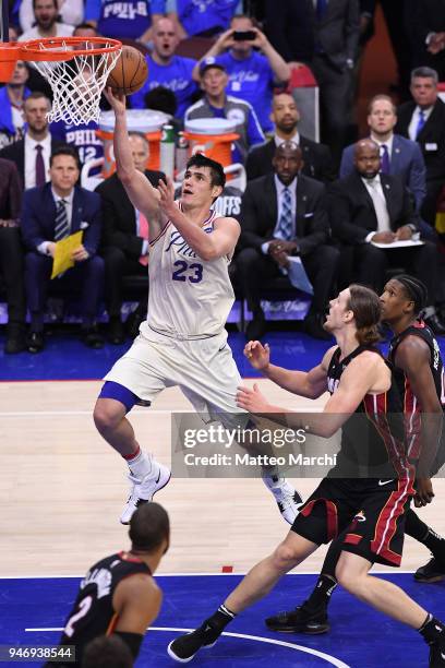 Ersan Ilyasova of the Philadelphia 76ers lays up a shot against Kelly Olynyk of the Miami Heat during game one of round one of the 2018 NBA Playoffs...