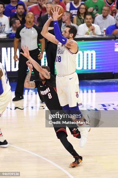 Marco Belinelli of the Philadelphia 76ers shoots the ball against Tyler Johnson of the Miami Heat during game one of round one of the 2018 NBA...