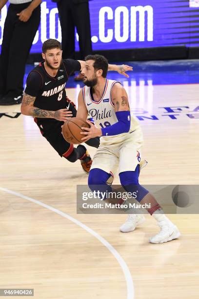 Marco Belinelli of the Philadelphia 76ers handles the ball against Tyler Johnson of the Miami Heat during game one of round one of the 2018 NBA...