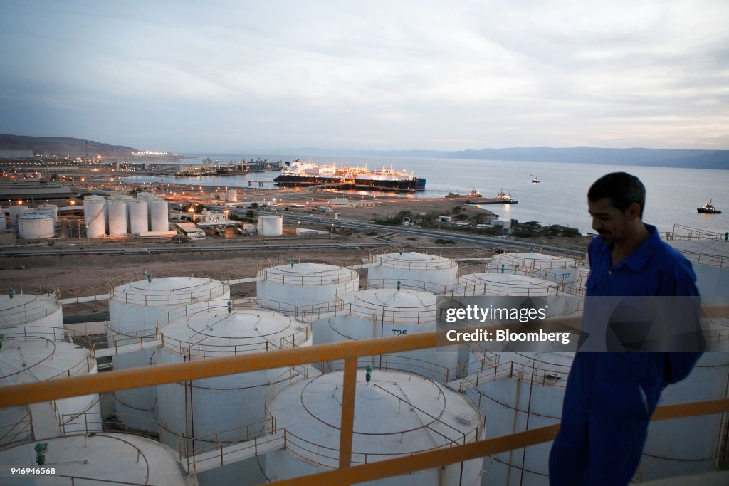 Lpg Operations A worker stands on top of an oil storage tank near the liquefied ...