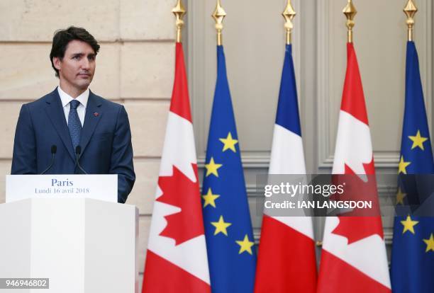 Canadian Prime Minister Justin Trudeau looks on as he holds a joint press conference with the French President at the Elysee Palace in Paris on April...