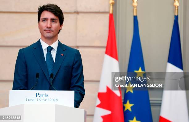 Canadian Prime Minister Justin Trudeau looks on as he holds a joint press conference with the French President at the Elysee Palace in Paris on April...