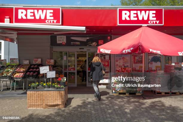 The Rewe Group is a German trading and tourism company. Exterior view of a food supermarket with the Rewe logo.