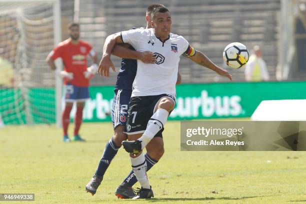 Esteban Paredes of Colo Colo fights for the ball with Christian Vilches of U de Chile during a match between U de Chile and Colo Colo as part of...