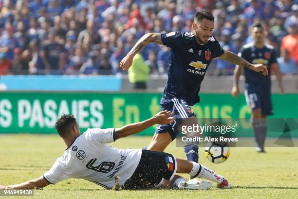 Mauricio Pinilla of U de Chile fights for the ball with Juan Manuel Insaurralde of Colo Colo during a match between U de Chile and Colo Colo as part...