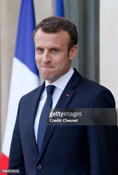 French president Emmanuel Macron smiles as Canadian Prime Minister Justin Trudeau leaves the Elysee Palace after their meeting on April 16, 2018 in...