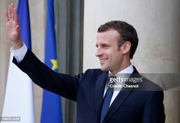 French president Emmanuel Macron gestures as Canadian Prime Minister Justin Trudeau leaves the Elysee Palace after their meeting on April 16, 2018 in...