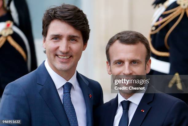 French president Emmanuel Macron accompanies Canadian Prime Minister Justin Trudeau after their meeting at the Elysee Palace on April 16, 2018 in...